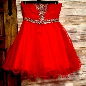 Red strapless rhinestoned short party dress.